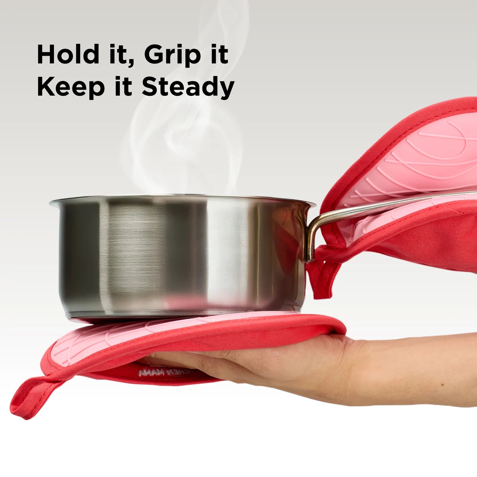 Two red Shopkitchenmama pot holders securely gripping a steaming stainless steel pot. Text overlay: "Hold It, Grip It, Keep It Steady."